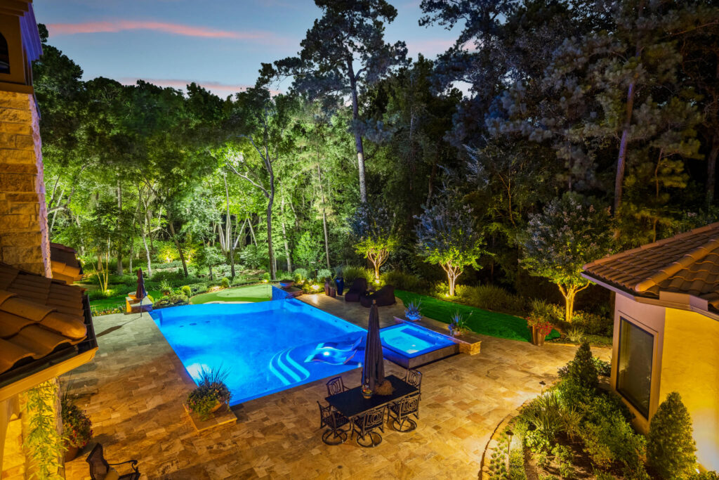 Level up your backyard pool area with dramatic landscape lighting.