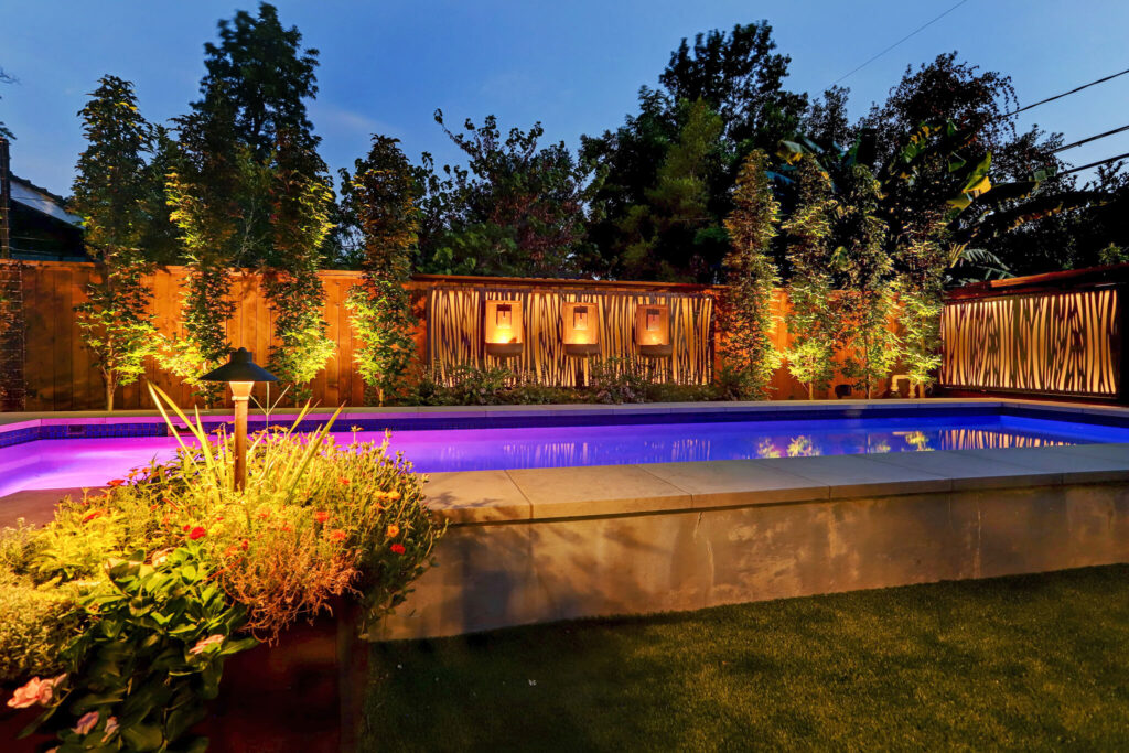 Enhanced backyard retreat with landscape lighting.